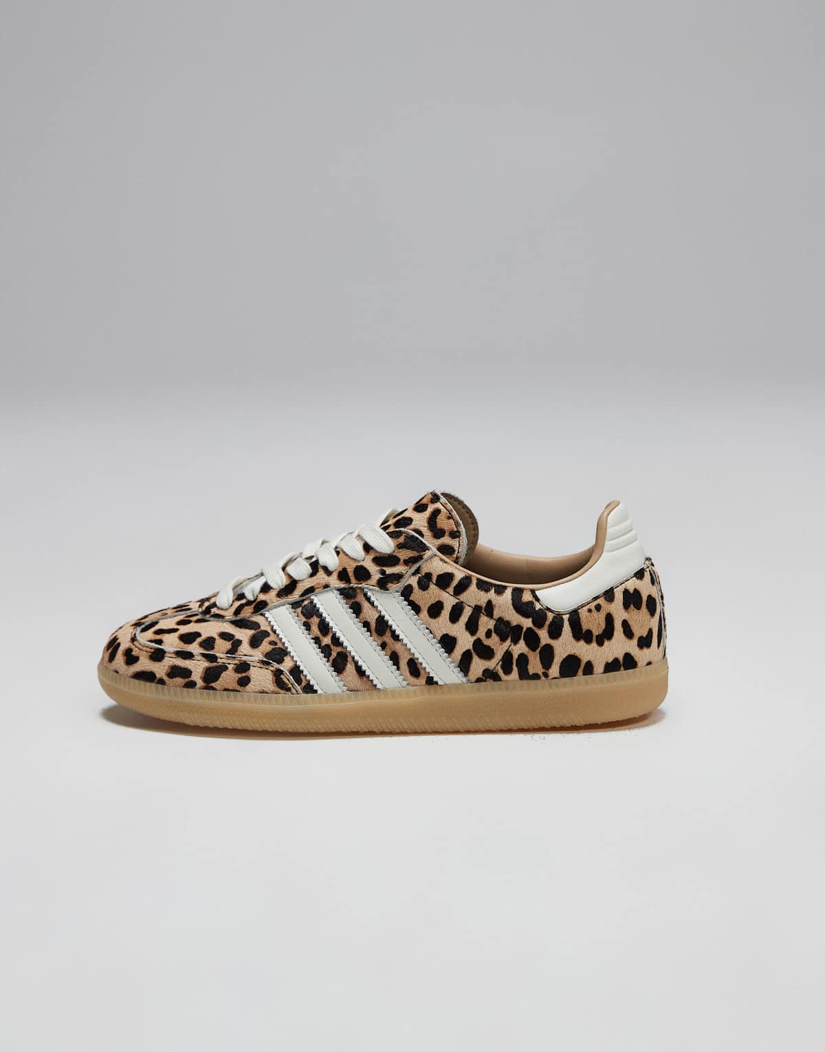 adidas Originals Samba OG trainers in leopard print with gum sole, side view