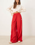 adidas Originals wide leg satin joggers in red, front view