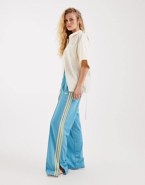 adidas Originals Firebird loose track pants in turquoise and yellow, front view