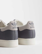 adidas Originals Superstar II trainers in grey and white, side view