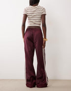 adidas Originals satin Firebird track pants in burgundy, side view