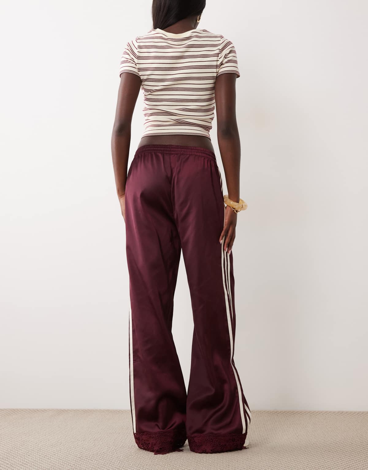 adidas Originals satin Firebird track pants in burgundy, side view