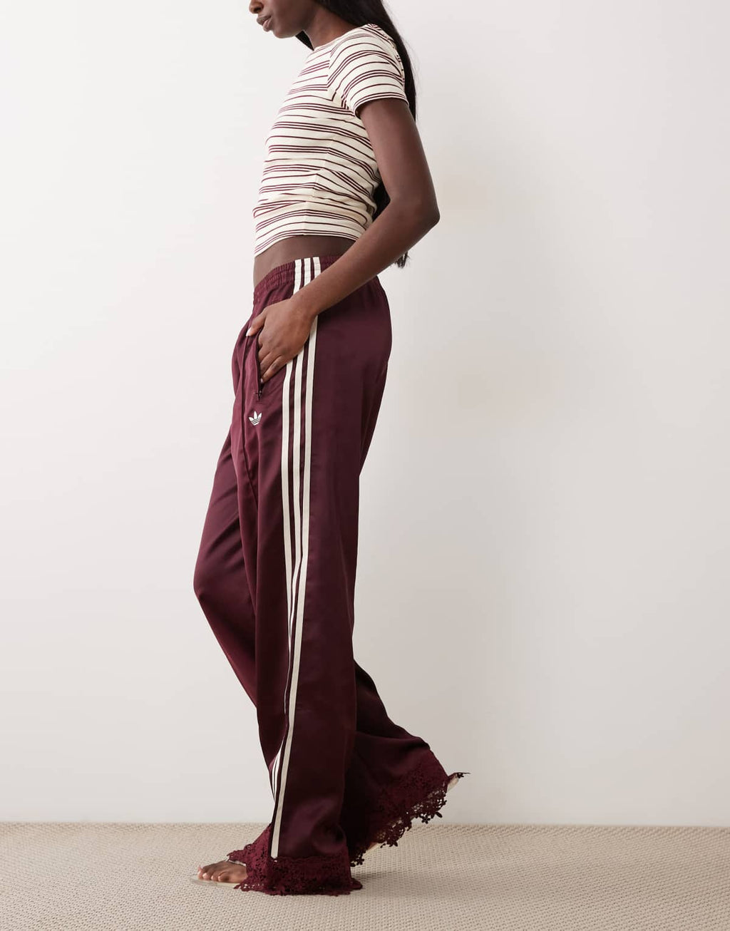 adidas Originals satin Firebird track pants in burgundy, detail of lace trim at cuff
