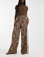 adidas Originals wide leg satin track pants in light brown snake, side view