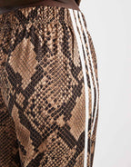 adidas Originals wide leg satin track pants in light brown snake, full length view