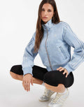 adidas Originals Firebird denim track top in light-wash blue, front view