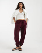 adidas Originals essential joggers in maroon, front view