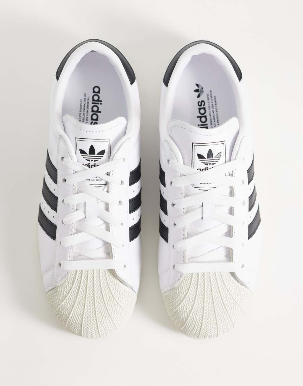 adidas Originals Superstar II lo pro trainers in white and black, side view