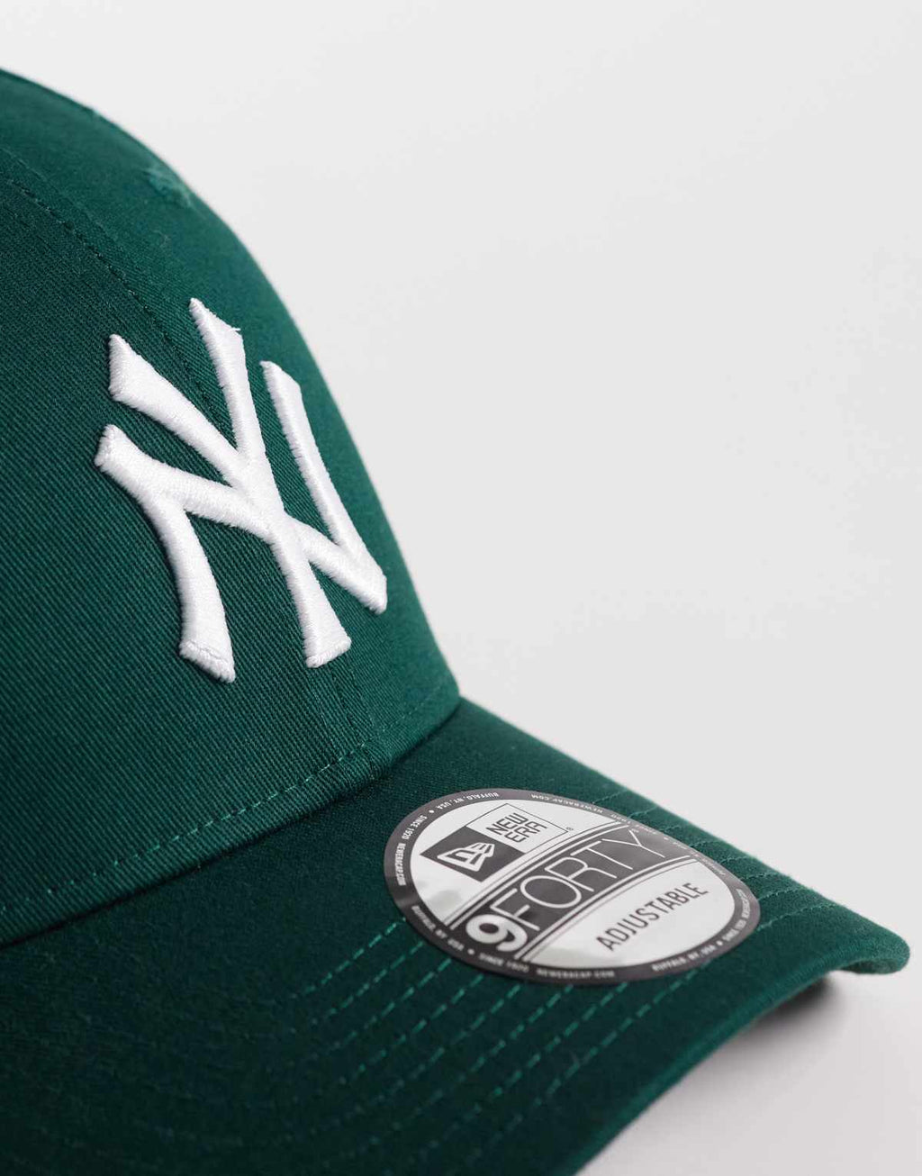New Era NY Yankees 9FORTY essential cap in dark green, side view