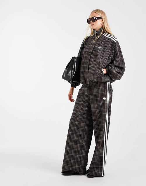 adidas Originals check track bottoms in night brown, front view
