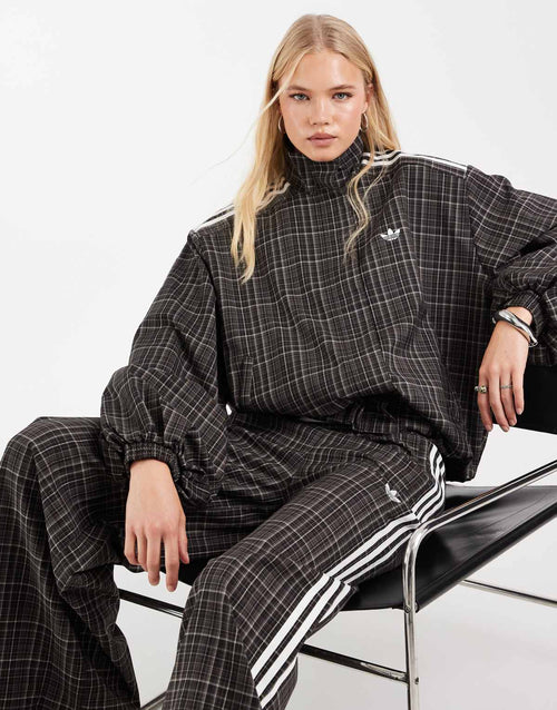adidas Originals check track bottoms in night brown, side view