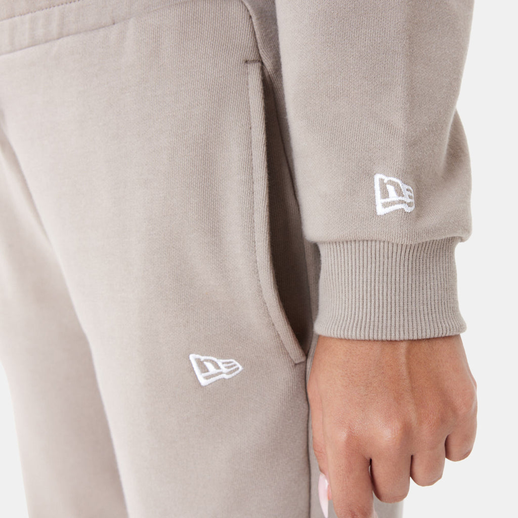 New Era women's Arch Wordmark cropped hoodie in beige, styled view