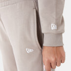 New Era women's Arch Wordmark cropped hoodie in beige, styled view